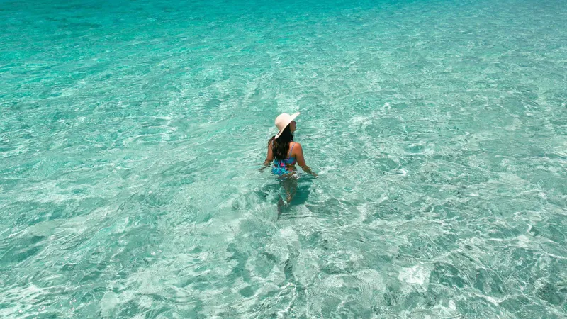 Snorkelers above the clear reef beside the Phantom Island sandbar on an ishigaki snorkeling boat tour in Okinawa, Japan