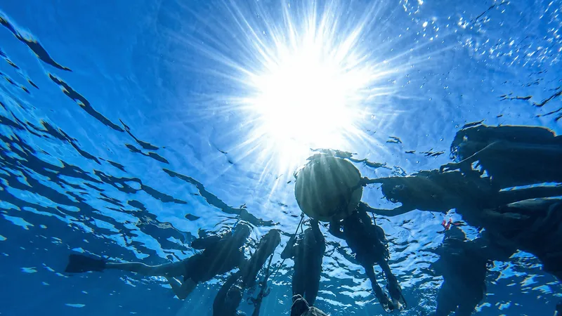 Local guide leading a snorkeler through the Blue Cave reef on an ishigaki snorkeling tour in Okinawa, Japan